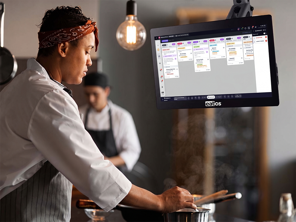 Chef reading kitchen tickets on a kitchen display